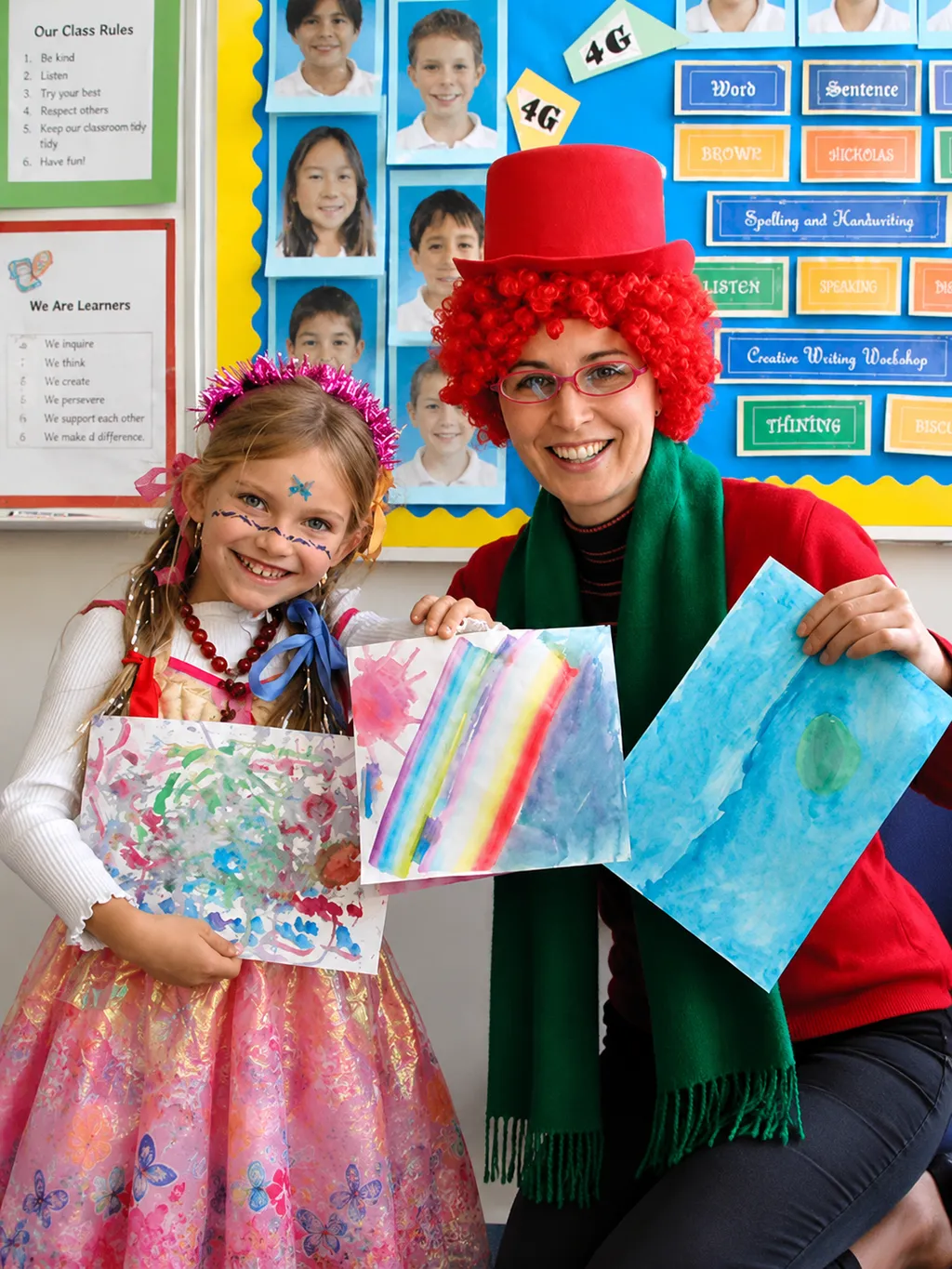 Donna in a clown costume with a student showing her artwork